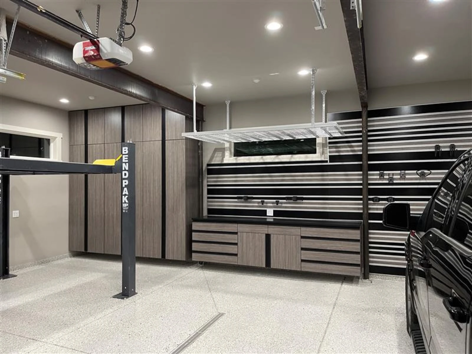 Made-in-USA melamine garage cabinets installed alongside a polyaspartic floor