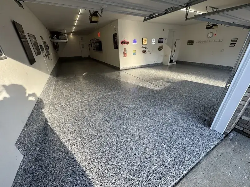 Polyaspartic flake garage floor with a deep, glossy finish